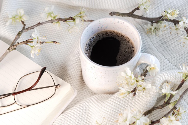 coffee, journal and eyeglass with flowers